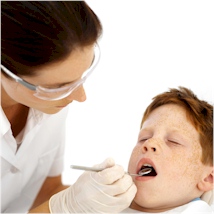 a dentist examining a child's mouth